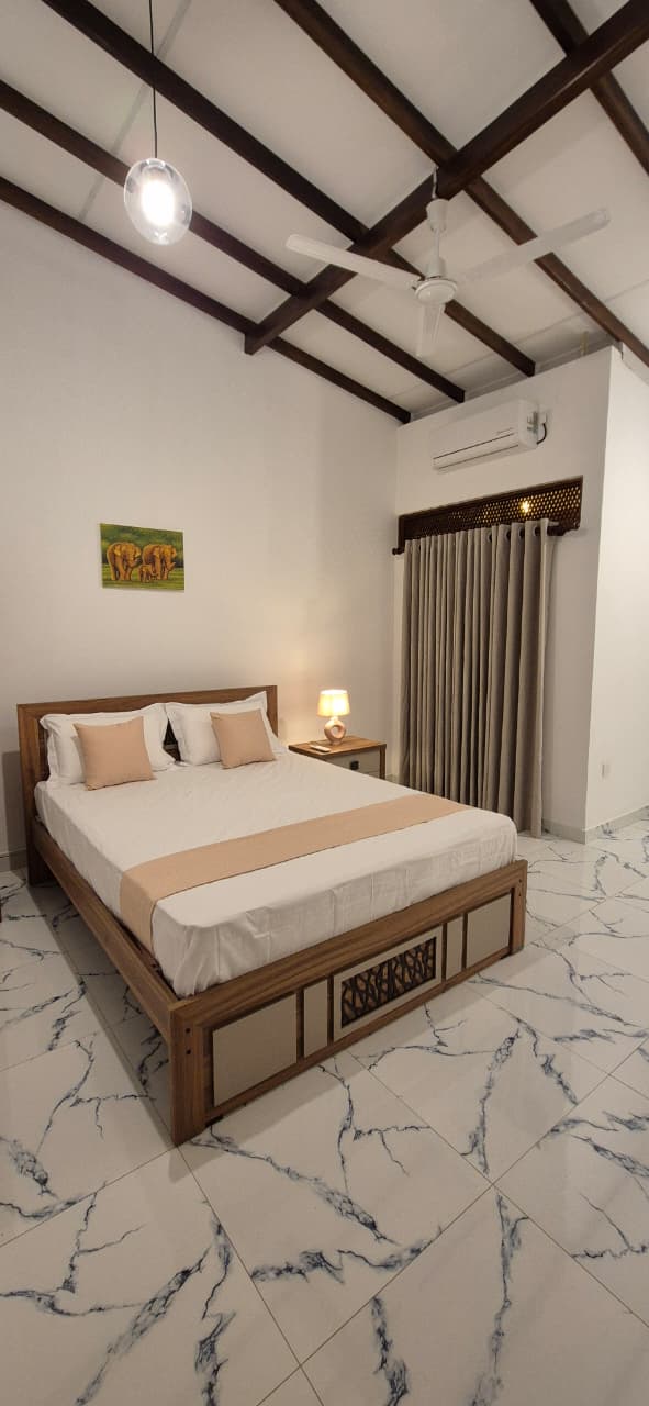 Traditional Wooden Bed with Sand Colored Accents and Elephant Painting